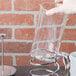 A hand pouring coffee into a Libbey glass French press carafe.