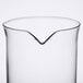 A clear glass beaker with a curved edge.