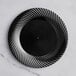 A black plastic plate with a wave design on it.