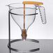 A Matfer Bourgeat polycarbonate automatic dispenser funnel with a yellow stick.