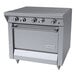 A stainless steel commercial hot top range with four control knobs and a standard oven, branded Garland.