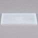 A white rectangular Flexsil lid on a gray surface.