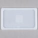 A white high-heat silicone steam table lid with a square in the middle.