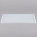 A white high-heat silicone lid on a white rectangular tray.