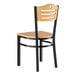 A Lancaster Table & Seating wooden side chair with a black frame and natural wood seat.