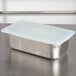 A Flexsil high-heat silicone lid on a stainless steel table.