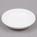 A Tuxton white china pasta/salad bowl on a gray surface.