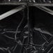 A black fabric bag with a string closure.