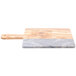 An American Metalcraft olive wood and gray marble serving board with a wooden handle.