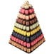 A black Matfer Bourgeat pyramid display stand with a pyramid of different colored macarons.