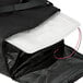 A black Cres Cor insulated food delivery bag with a white object inside.