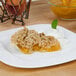A slice of peach pie with whipped cream on a plate.
