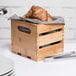 An American Metalcraft bamboo wood crate with a croissant in it.