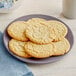 A plate of sugar cookies on a table.