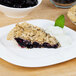 A plate of Lucky Leaf Blueberry Pie with whipped cream and mint on top.