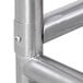 A metal corner of an Advance Tabco equipment filler table with a screw.
