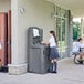 A group of girls washing their hands at a Crown Verity portable hand sink.