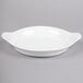 A white bowl with a handle.