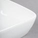 A close up of a Libbey Aluma White Porcelain square bowl.