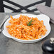 A Libbey white porcelain dish with pasta and a fork.