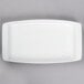 A white rectangular porcelain tray with a silver handle.