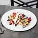 A Libbey aluma white porcelain tray with waffles, ice cream, and strawberries.