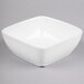 A Libbey white square bowl on a gray surface.