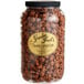 A jar of Grandma Jack's Gourmet Chocolate Caramel Popcorn on a table.