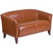 A Flash Furniture Hercules Imperial Cognac leather loveseat with wooden legs.