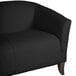 A Flash Furniture black leather sofa with wooden legs.