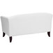 A Flash Furniture white leather loveseat with wooden legs.