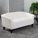 A white Flash Furniture Hercules Imperial loveseat with wooden legs.