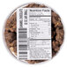 A container of Grandma Jack's chocolate caramel popcorn on a table with a label.