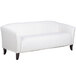 A Flash Furniture white leather sofa with wooden legs.