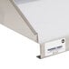 A close-up of a stainless steel wall mount shelf.