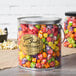 A gallon tin of Grandma Jack's Tutti Frutti popcorn with colorful lollipops.