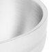 A close up of a Vollrath pearl white stainless steel double wall serving bowl with a beehive design.