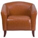 a brown leather chair with wooden legs