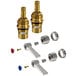 A close-up of two Advance Tabco brass faucet cartridges with black and brass connectors.