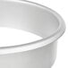 A silver round stainless steel in-counter trash chute.