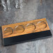 A Cal-Mil faux wood rectangular tray with four glasses on it.