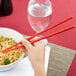 a person holding chopsticks in their hands