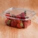 A Dart ClearPac plastic deli container of strawberries with a dome lid.