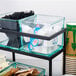 A black Cal-Mil condiment display with glass jars on a black tray.