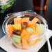 A Dart plastic bowl filled with fruit salad.