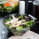 A salad in a Dart plastic bowl with a flat lid.