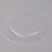 A Fineline Flairware clear plastic plate with a scalloped edge.