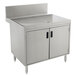 A stainless steel Advance Tabco Prestige Series drainboard cabinet with doors and a shelf.