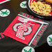 A plate of macaroni and cheese with a Creative Converting Ohio State University napkin on a table.