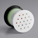 A white circular Avantco vacuum breaker with black and green components.
